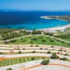 Vista panoramica di una spiaggia e prato verde.